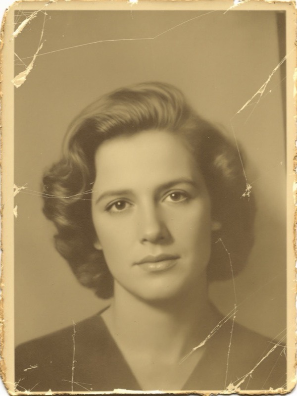 Before restoration - a damaged old vintage photo with scratches, stains and faded, yellowed tones